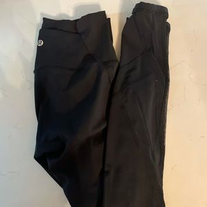 Black Lululemon leggings with mesh detail, size 4